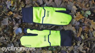 Pair of Gore-Tex Infinium Split gloves on a leafy ground