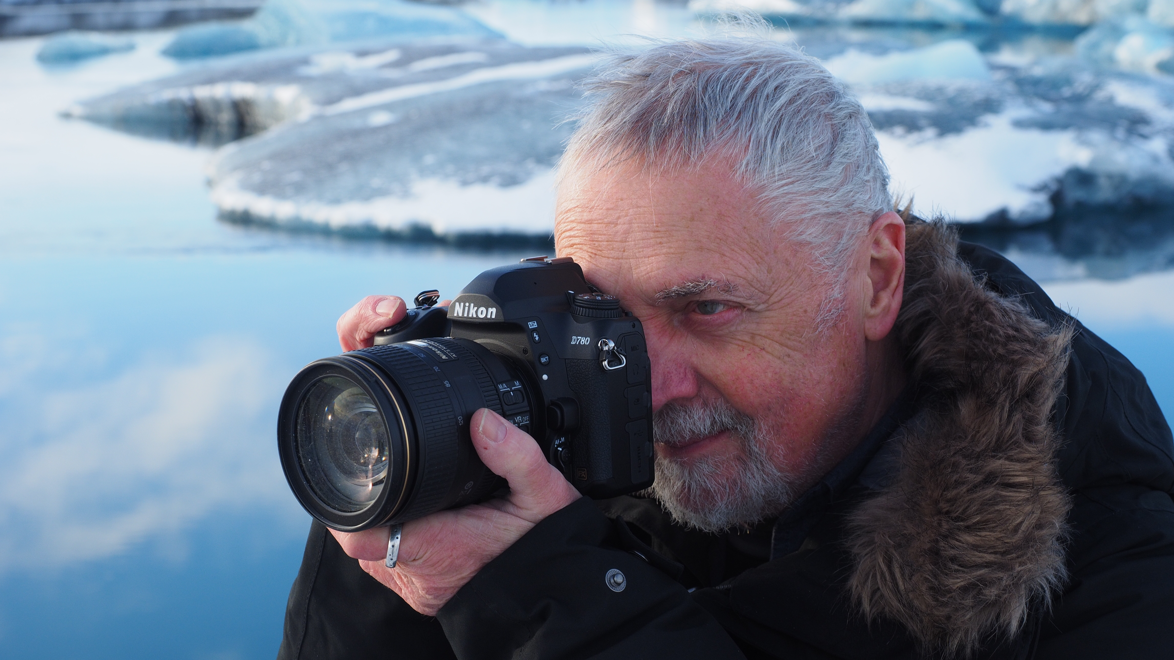 Man holding Nikon D780 in snow-covered landscape