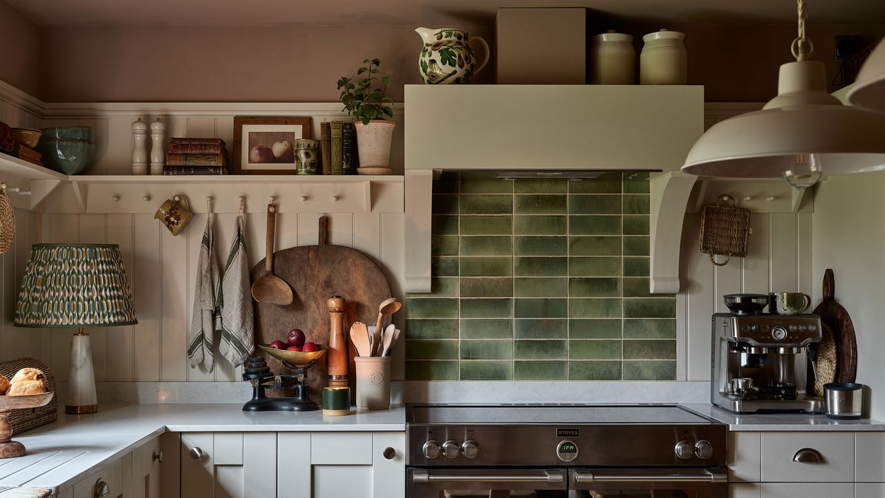 White kitchen panelling with green splashback over the oven