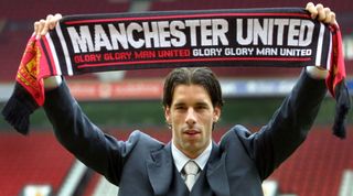 2001: Ruud van Nistelrooy poses holding a scarf after signing for Manchester United.