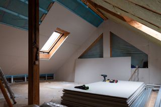 The inside of a loft being plasterboarded during conversion