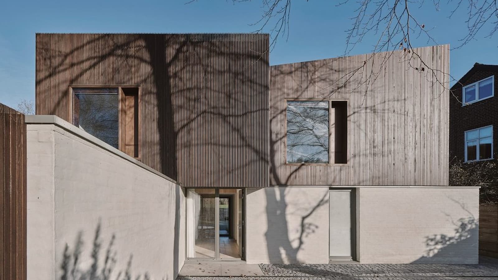A self build with striped wall panelling and a front concrete exterior