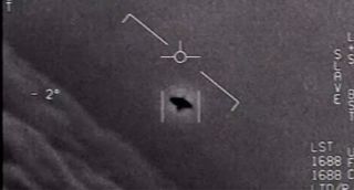 An unidentified aerial phenomenon object appearing as a shadow in a Navy jet camera