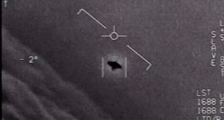 a black and white image with a square surrounding a manta-ray shaped object in the sky