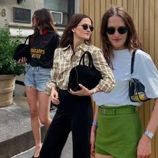 Eliza Huber wearing basics in different outfits, including tank tops, button-down shirts, jean shorts, trousers, and more. 