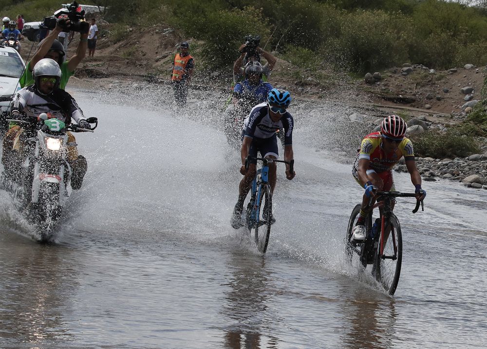 Final breakaway riders Daniel Zamora (Agrupacion Virgen De Fatima) and Cesar Paredes (Medellin) ride through standing water 10km from the finish of stage 4 in San Juan