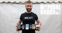 Jesse Matthewson of KEN mode shows off his pedalboard backstage at ArcTanGent Festival 2024