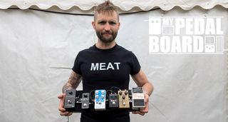 Jesse Matthewson of KEN mode shows off his pedalboard backstage at ArcTanGent Festival 2024