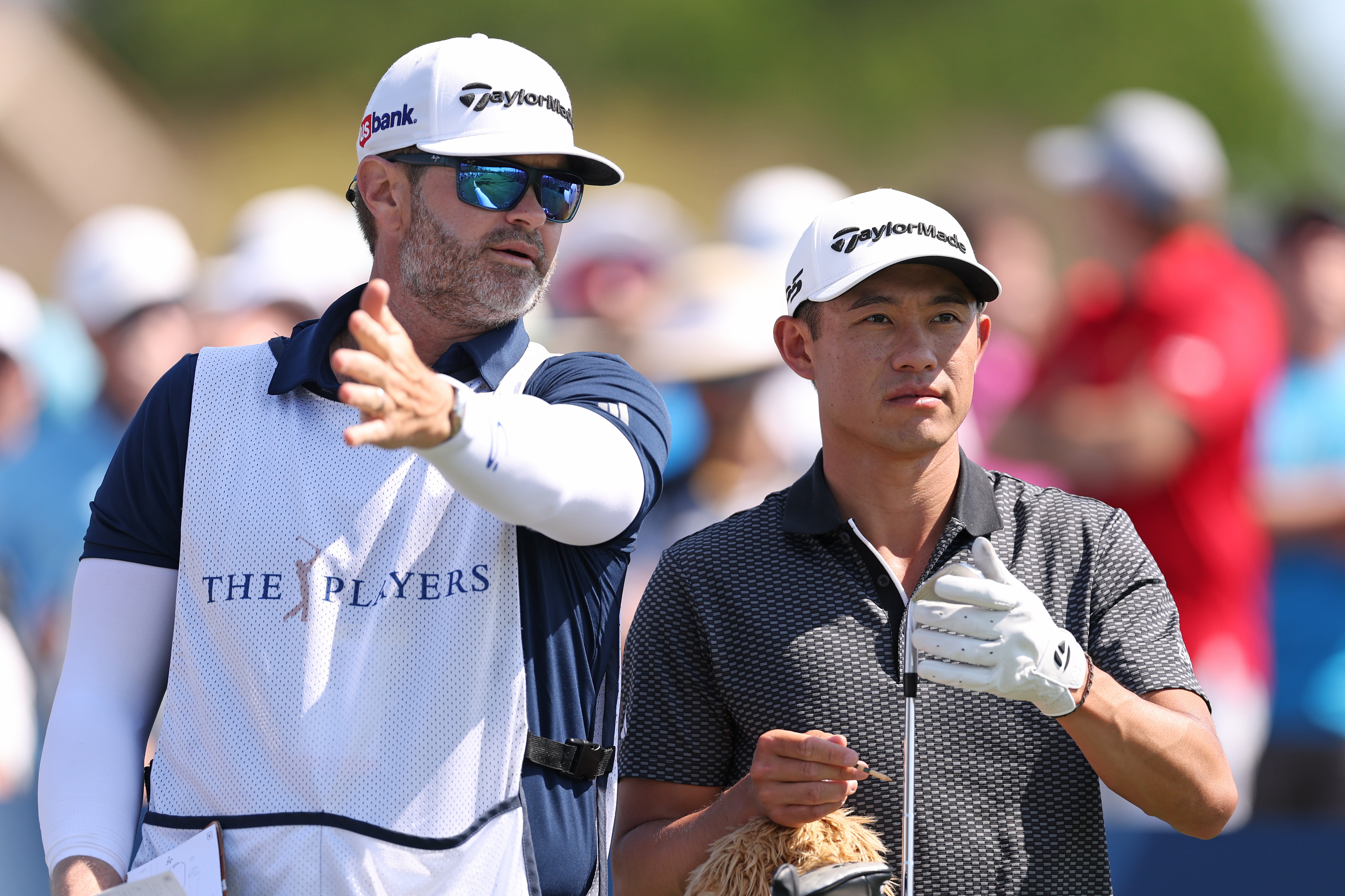 Collin Morikawa chats to his caddie