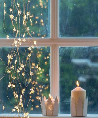 star fairy lights at a window by lightzey