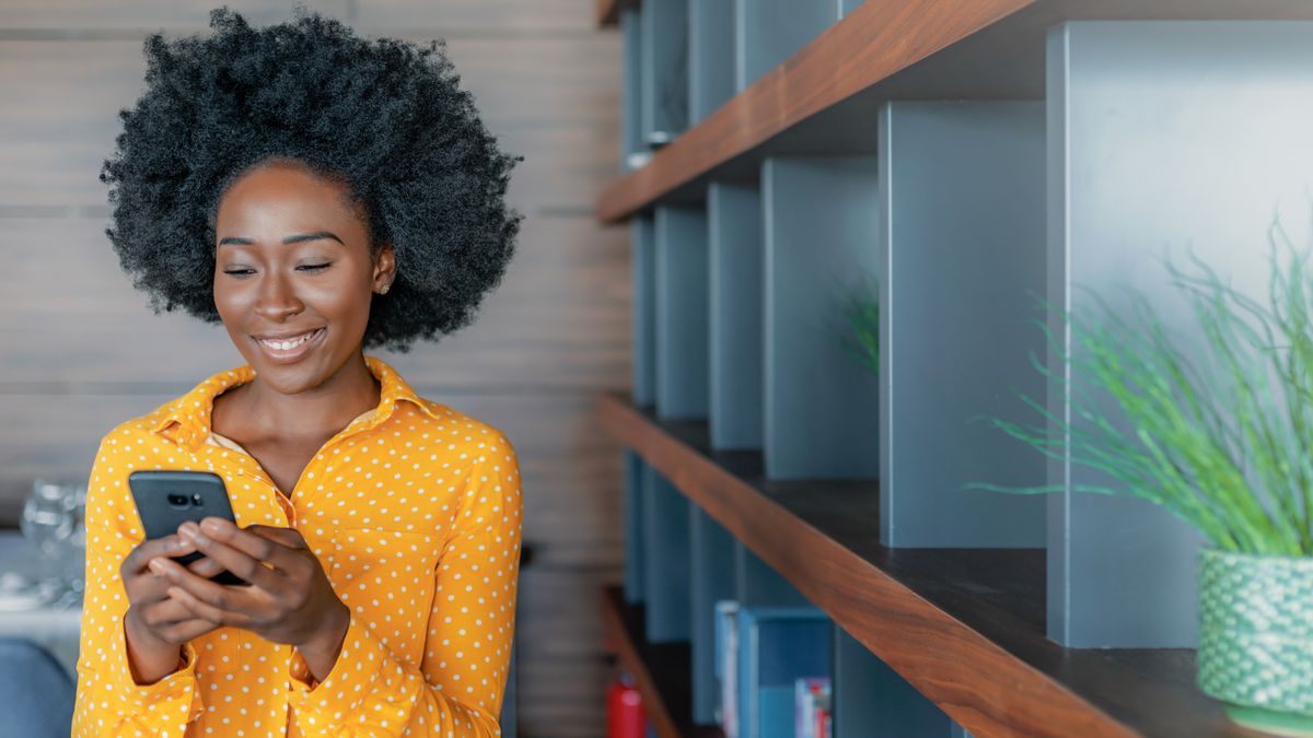 Woman smiling as she uses one of the best phablets