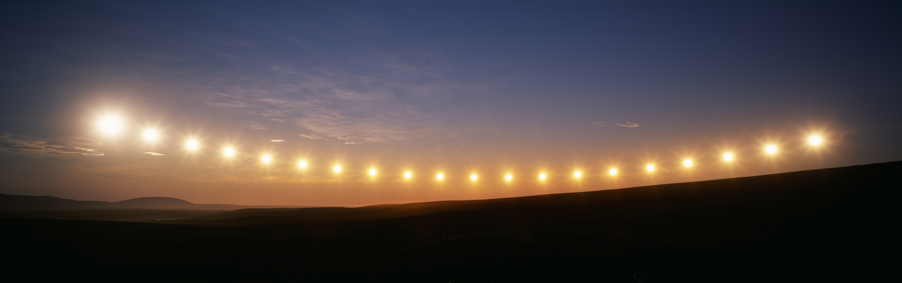 Multiple exposure of midnight sun passing due north on a summer night 175 miles north of Arctic Circle. | Location: Toolik Lake, Alaska, USA.