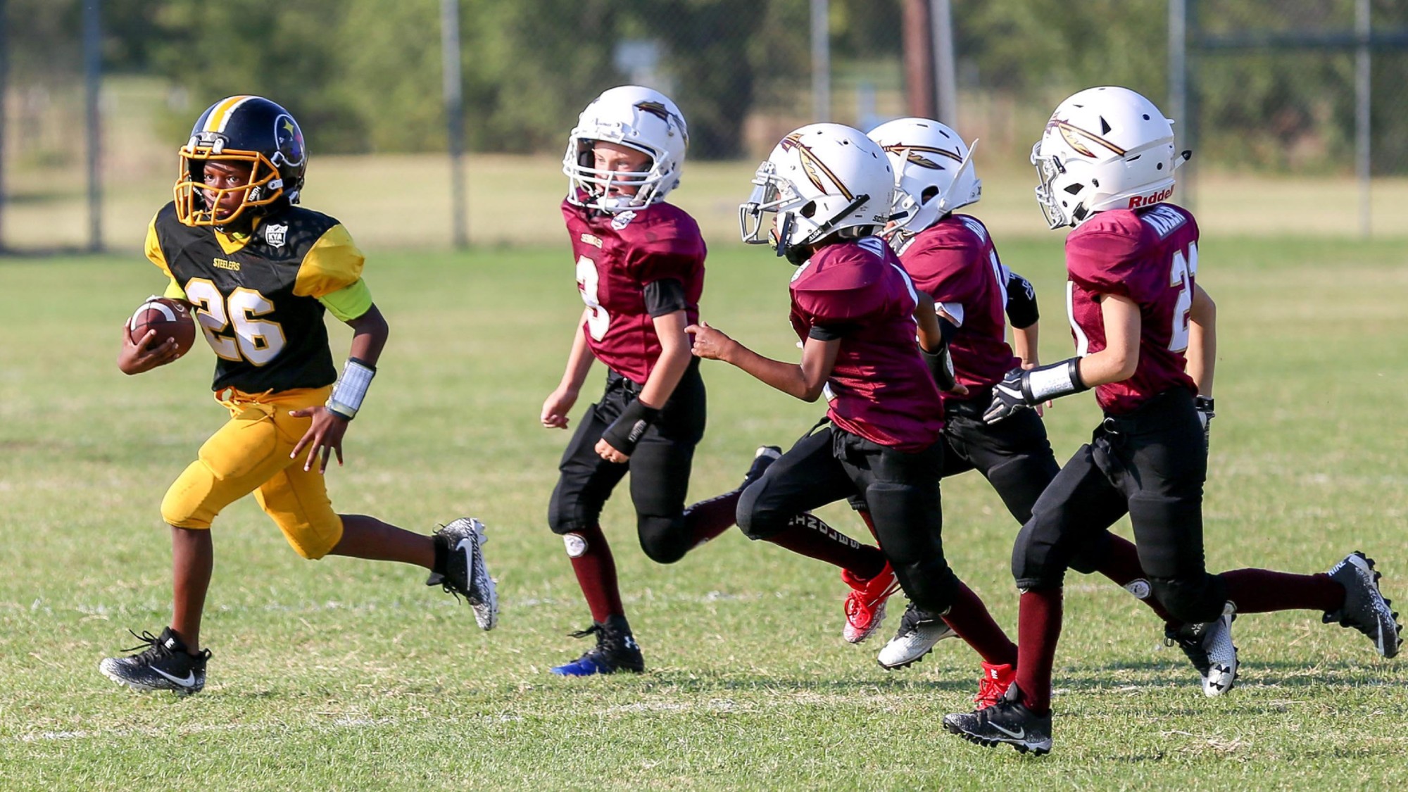Kids play football in Texas. 
