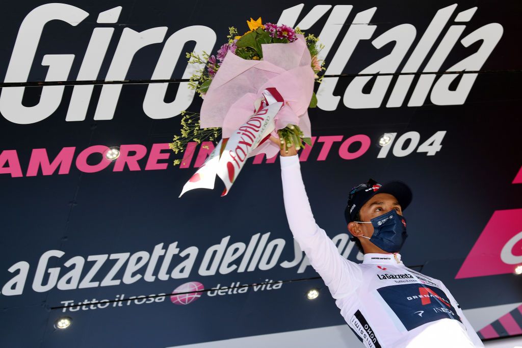 FOLIGNO ITALY MAY 17 Egan Arley Bernal Gomez of Colombia and Team INEOS Grenadiers white best young jersey celebrates at podium during the 104th Giro dItalia 2021 Stage 10 a 139km stage from LAquila to Foligno Miss Hostess Mask Covid safety measures Trophy Flowers girodiitalia Giro on May 17 2021 in Foligno Italy Photo by Stuart FranklinGetty Images