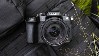 The Panasonic G80 camera resting on a backpack