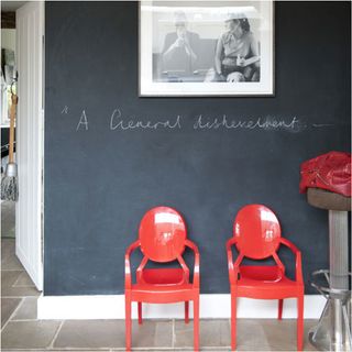 blackboard wall with red arm chair and photo frame on wall