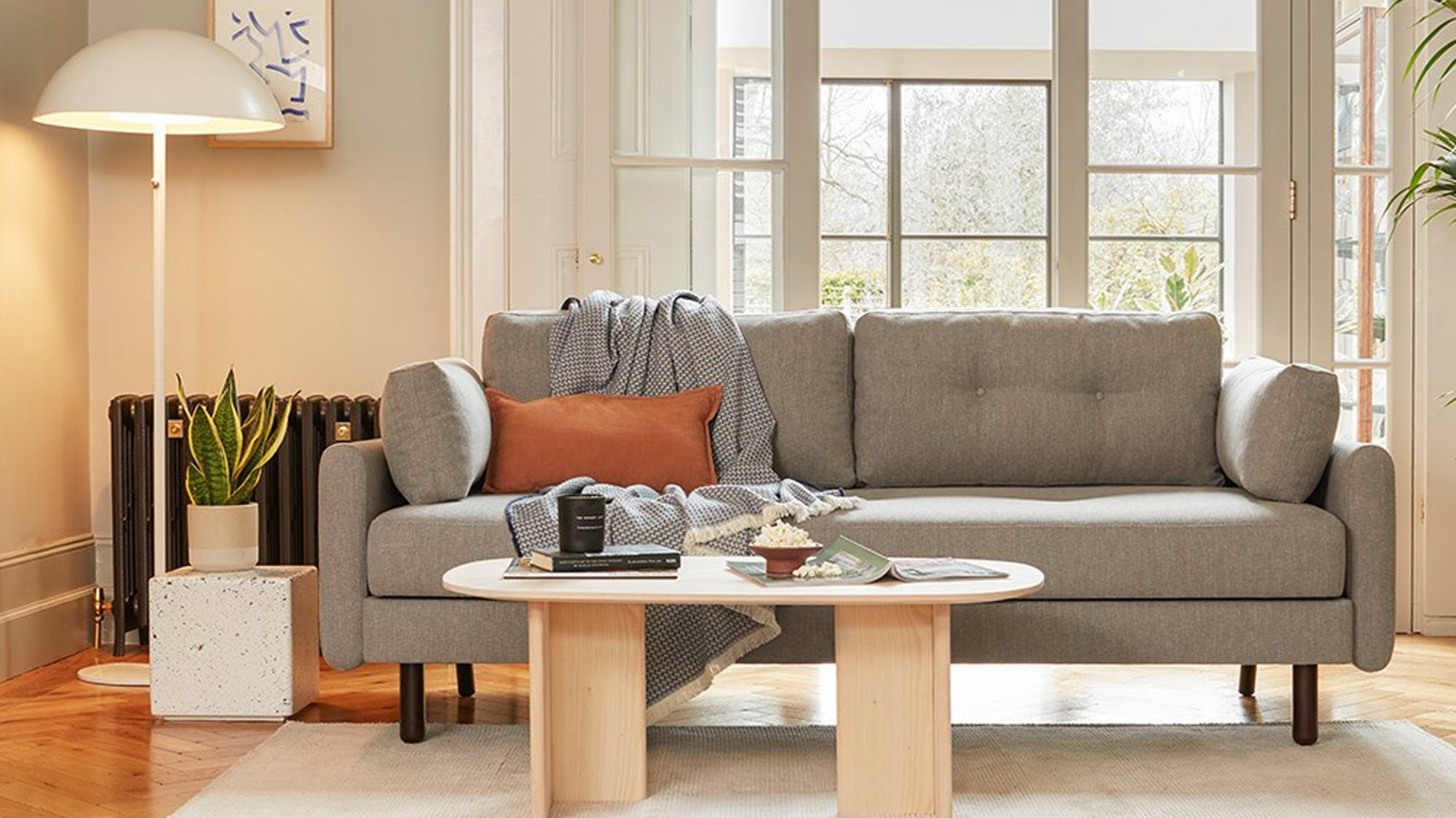A grey flatpack sofa bed in a living room