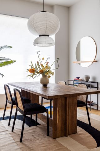 Minimalist Dining room with rectangular wood table and rattan chairs