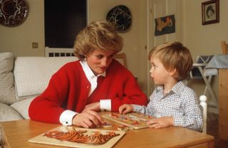 Princess Diana and Prince William in playroom doing a puzzle