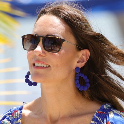 Princess Kate wearing Ray-Ban sunglasses and large blue dangle earrings