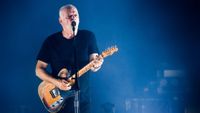 David Gilmour playing guitar and singing live on stage