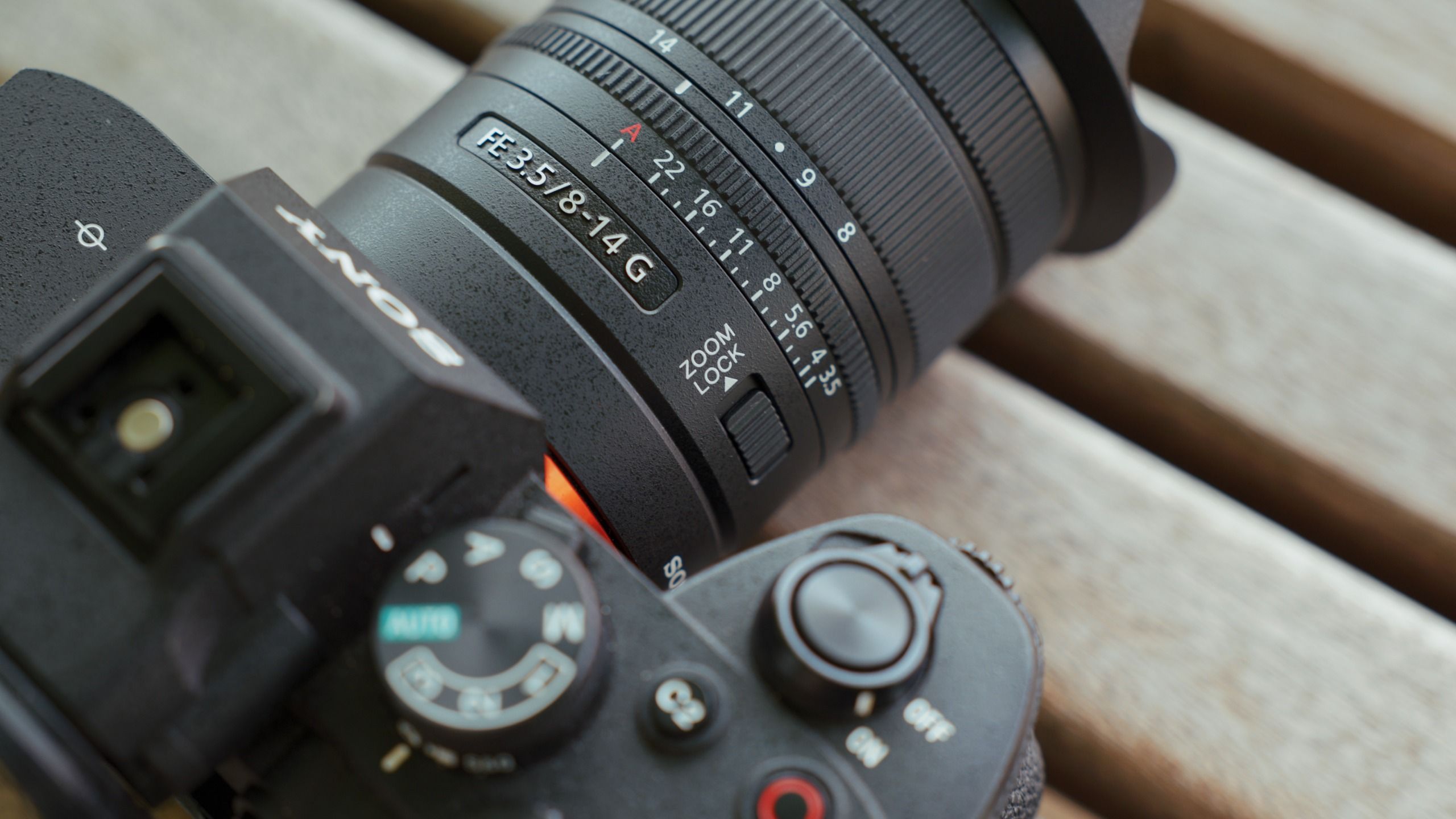 Close-up of the zoom and aperture rings, markings and zoom lock switch on the Sony FE 8-14mm F3.5 G lens.