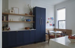 A kitchen with navy blue cabinets