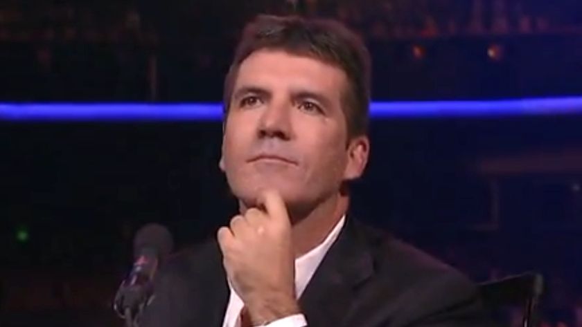 SImon Cowell watching performance in final American Idol episode.