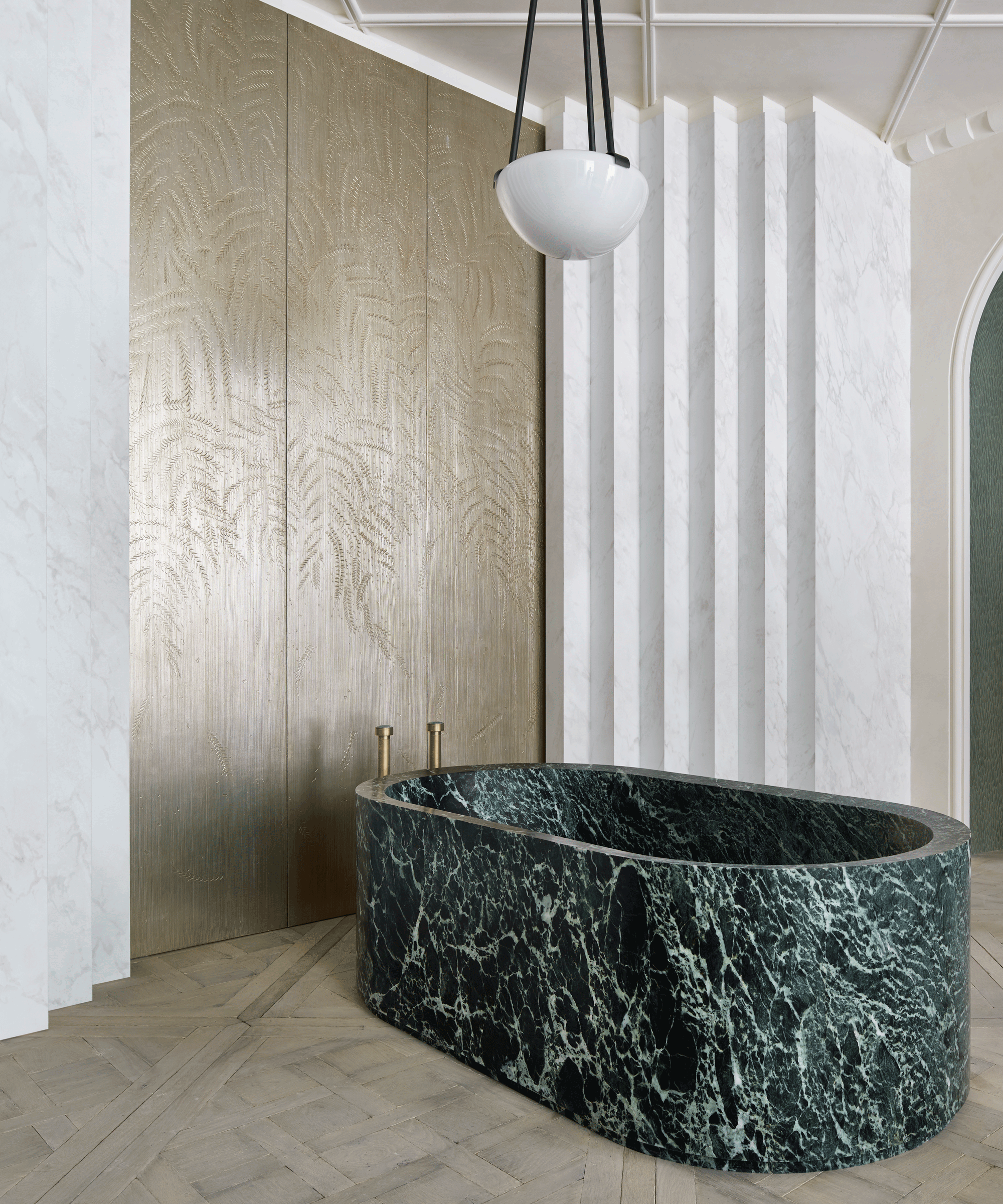 An example of bathroom wall ideas showing a black and green marble bath with a 3D wall