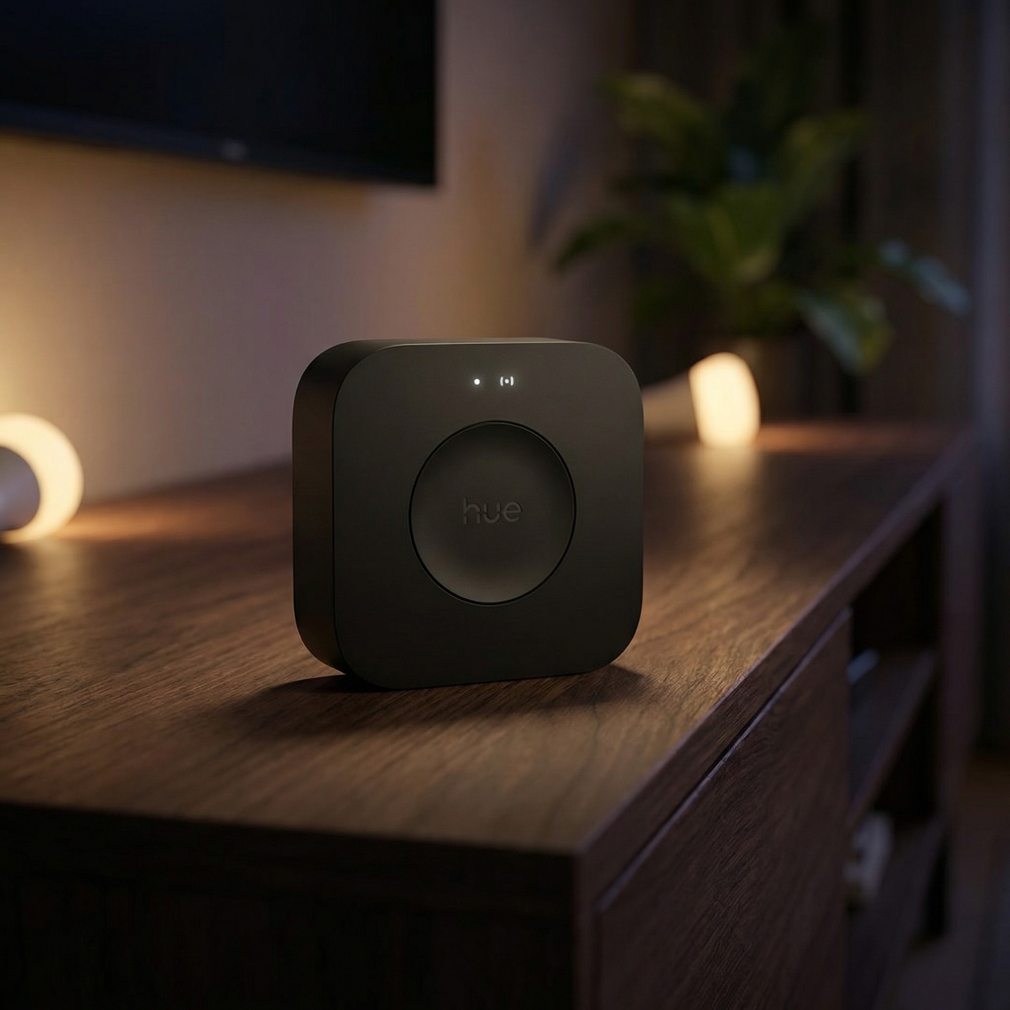 Phillips Hue Bridge Pro, one of the best smart hubs, on a dark wooden cabinet