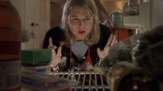 Bridget looking inside her refrigerator with food on her face in Bridget Jones's Diary