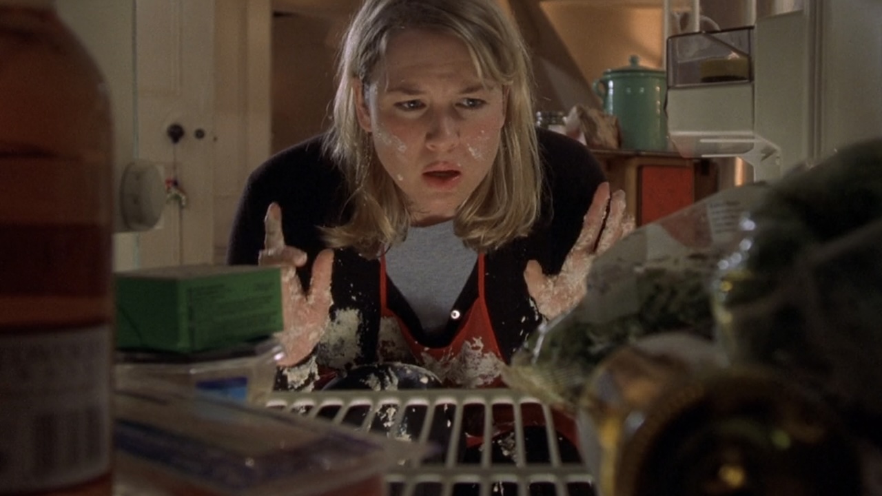 Bridget looking inside her refrigerator with food on her face in Bridget Jones's Diary