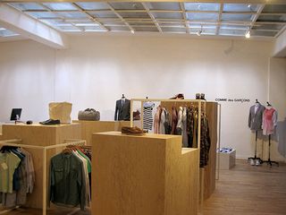 Clothing shop with pale wood flooring and display units