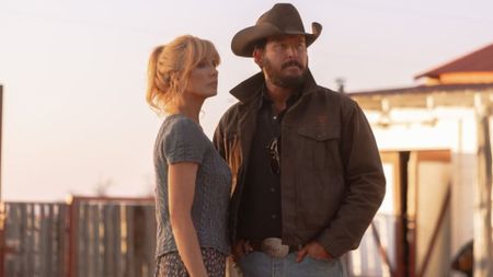 Beth and Rip stand in front of a fence