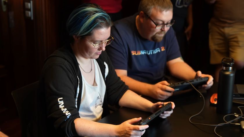 Two people play Subnautica 2 on portable gaming handhelds