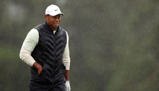Tiger Woods grimaces in the rain