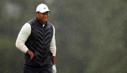 Tiger Woods grimaces in the rain