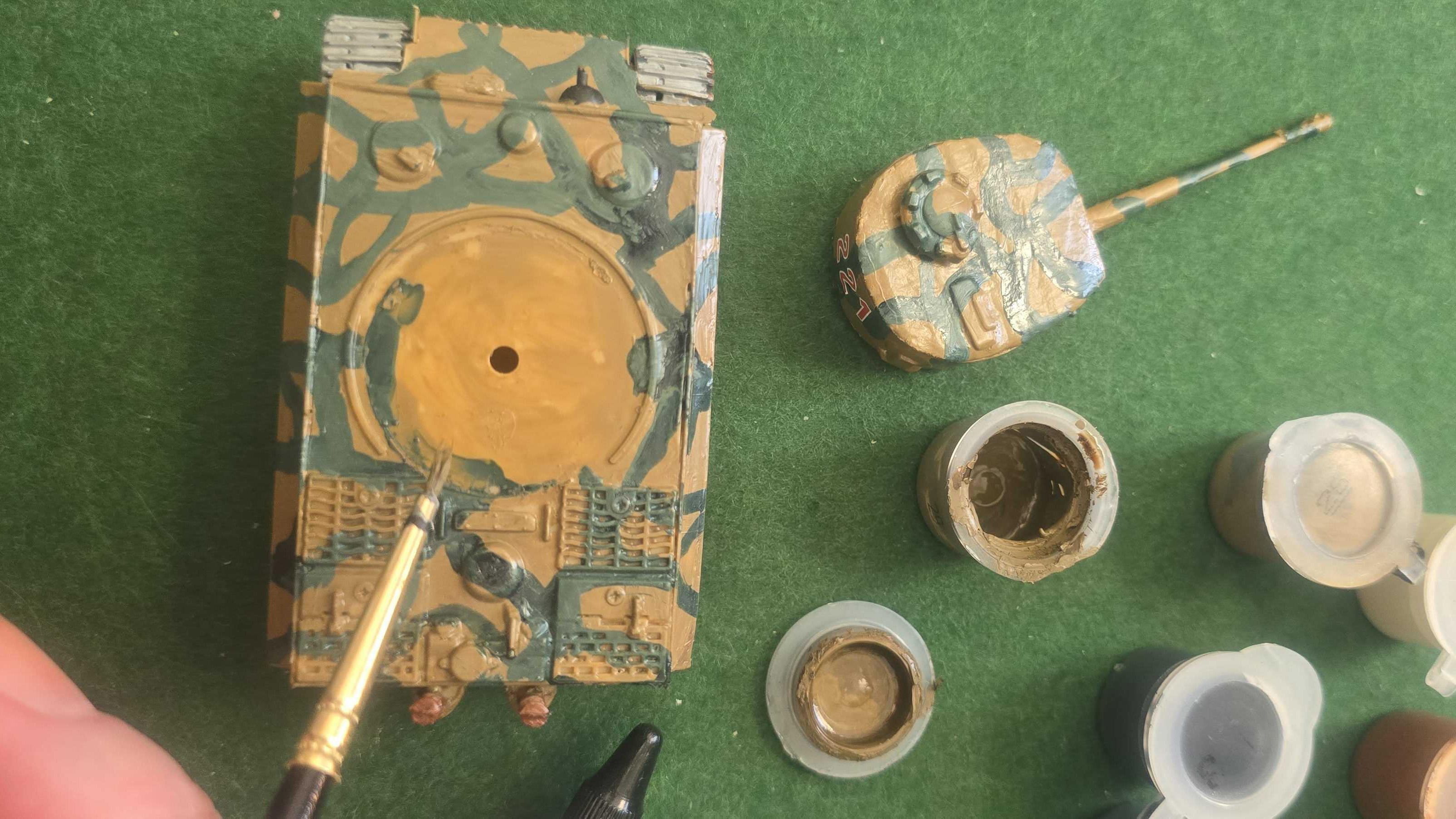 Painting the top of the tank, with paint pots to the side