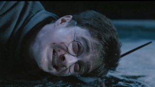 Harry Potter laying on the ground in pain