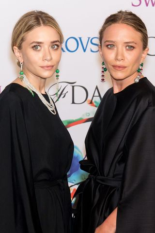 The Olsen sisters, both with their hair tied back in a bun.