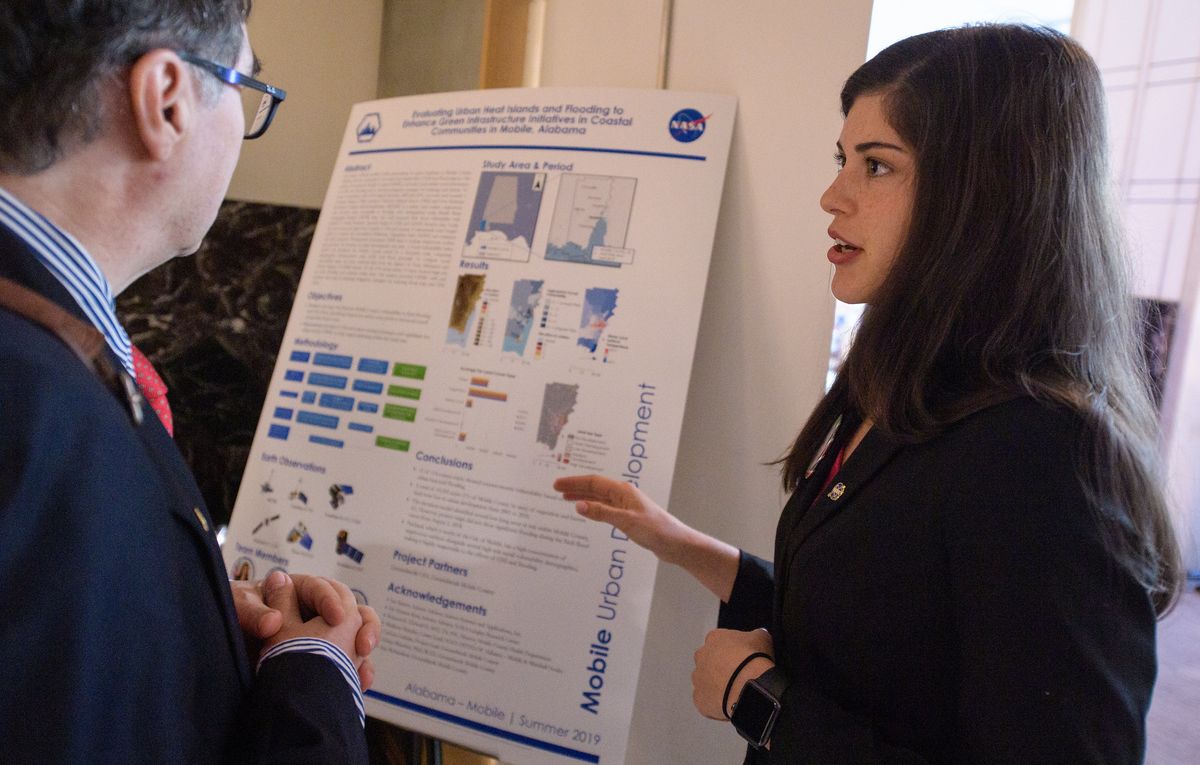 A young professional discussing their project during the 2019 Annual Earth Science Applications Showcase, held on Aug. 1, 2019, at NASA Headquarters in Washington, DC..