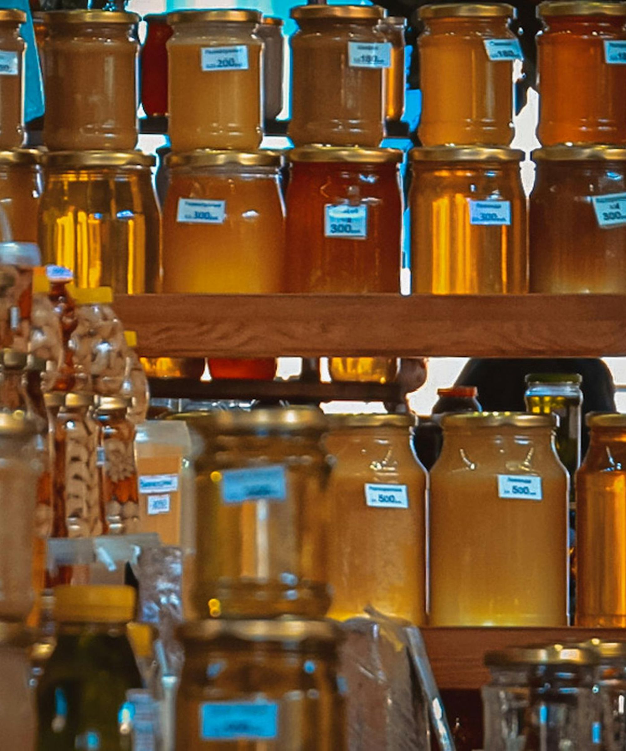 Shelves of honey in glass jars
