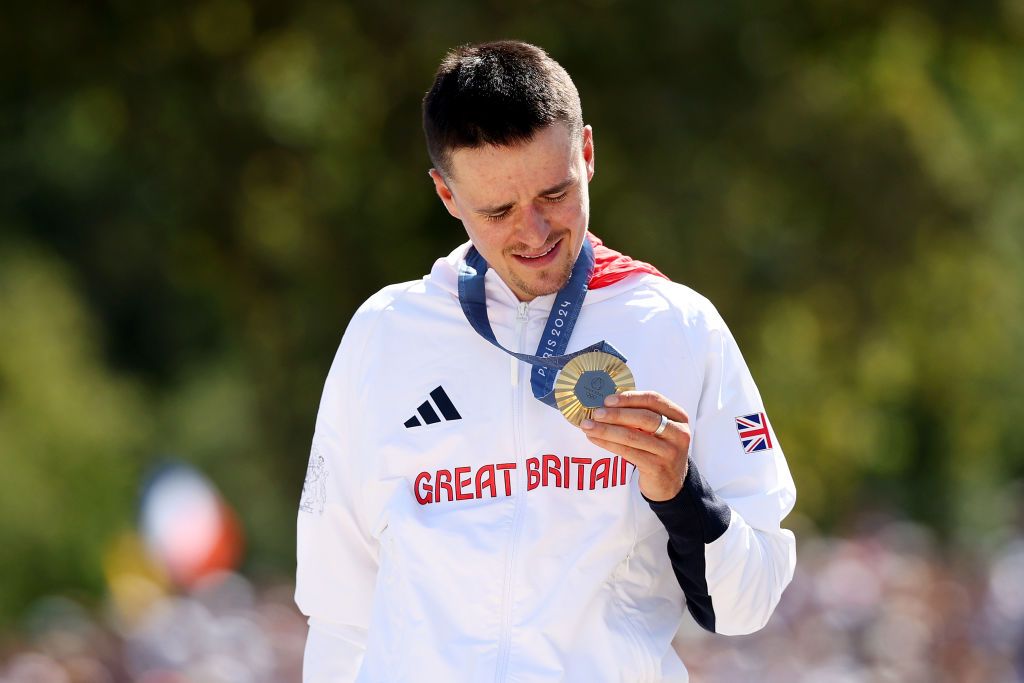 ELANCOURT FRANCE JULY 29 Gold medalist Thomas Pidcock of Team Great Britain poses on the podium during the Mens CrossCountry on day three of the Olympic Games Paris 2024 at Elancourt Hill on July 29 2024 in Elancourt France Photo by Jared C TiltonGetty Images