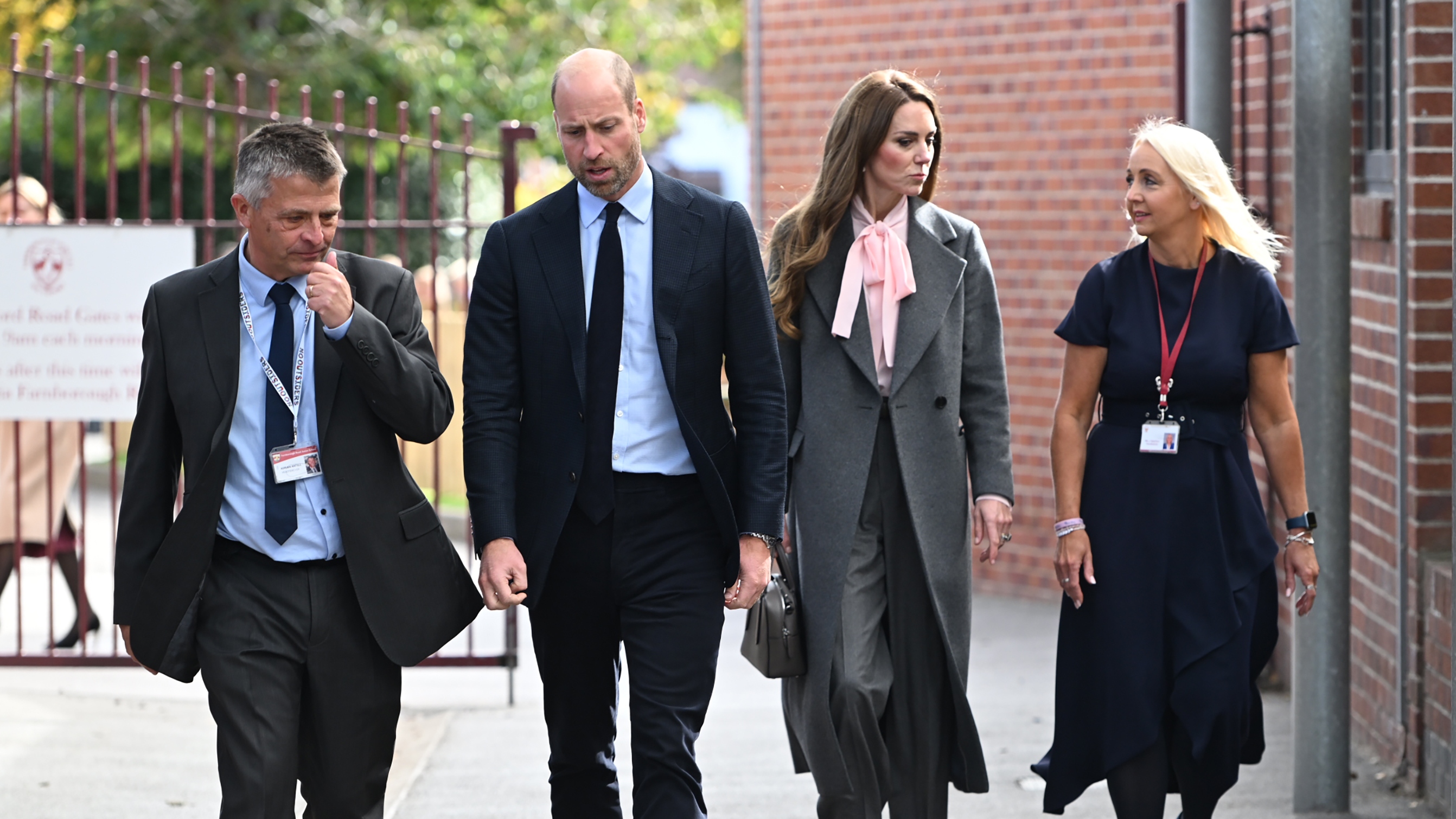 Prince William, Prince of Wales and Catherine, Princess of Wales walk with with Junior School Head Adrian Antell and Infants Head Jennie Sephton during a visit to Farnborough Road Infant and Junior School on September 23, 2025