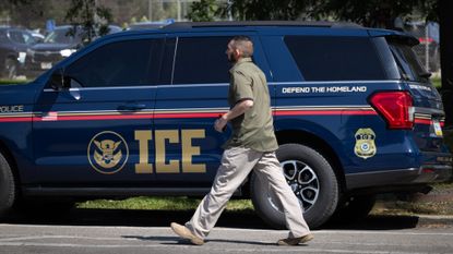 A man walks past an ICE vehicle in Chicago on Sept. 8, 2025.