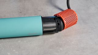 the dyson airwrap ID in teal and terracotta colorway (patina and orange) with a lapis case, with a brush, hairfryer, curling wand attachments