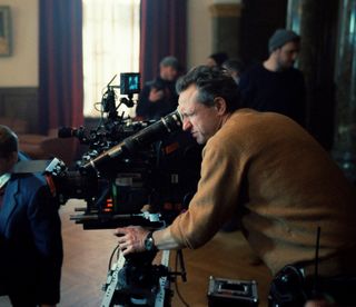 Making the visual design of The Brutalist; a man uses a large film camera on a set