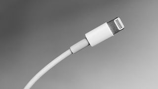 An Apple Lightning Cable on a grey background