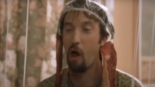 Tom Green wearing a shower cap with meat dangling from his ears in Freddy Got Fingered