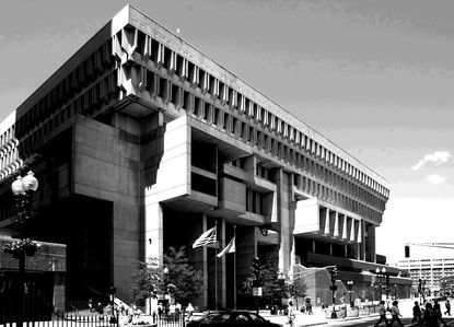 Black and white image of Boston City Hall with people walking outside